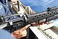Navy sailor loading an M203 attached to an M16A2 with a high explosive round.
