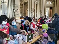 Civilians help Ukrainian refugees at one of the aid points in Hungary with several boxes containing resources