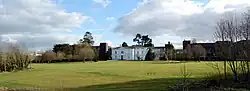 White, two-story house across a lawn
