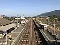 A view of the platforms and tracks, looking east. The siding can be seen in the distance.