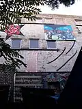 The face of the squat 'Villa Squattus Dei&nbsp;[nl]' in Leuven (Belgium). Also depicted: caricature of Louis Tobback.