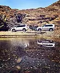 Day trippers pass abundant water in the Wadi Asimah in the summer months