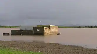 Warar, a natural temporary lake, in 2008, flooding a house built in the 1970s
