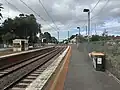 South-west bound view from Platform 2, with the Westgarth Street level crossing seen ahead, November 2024