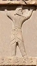 Engraving of a man wearing a helmet with a short sword in his cummerbund