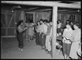 Japanese internees holding their first religious services meeting at the Poston Center.
